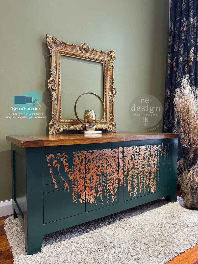 a chest of drawers  with the gold foil leafy transfer